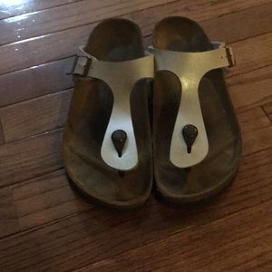 Pearl colored, flip-flop style Birkenstocks.